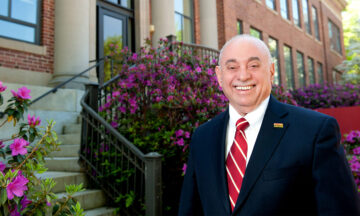 Louis Martin-Vega is standing outside Page Hall on NC State's Main Campus.