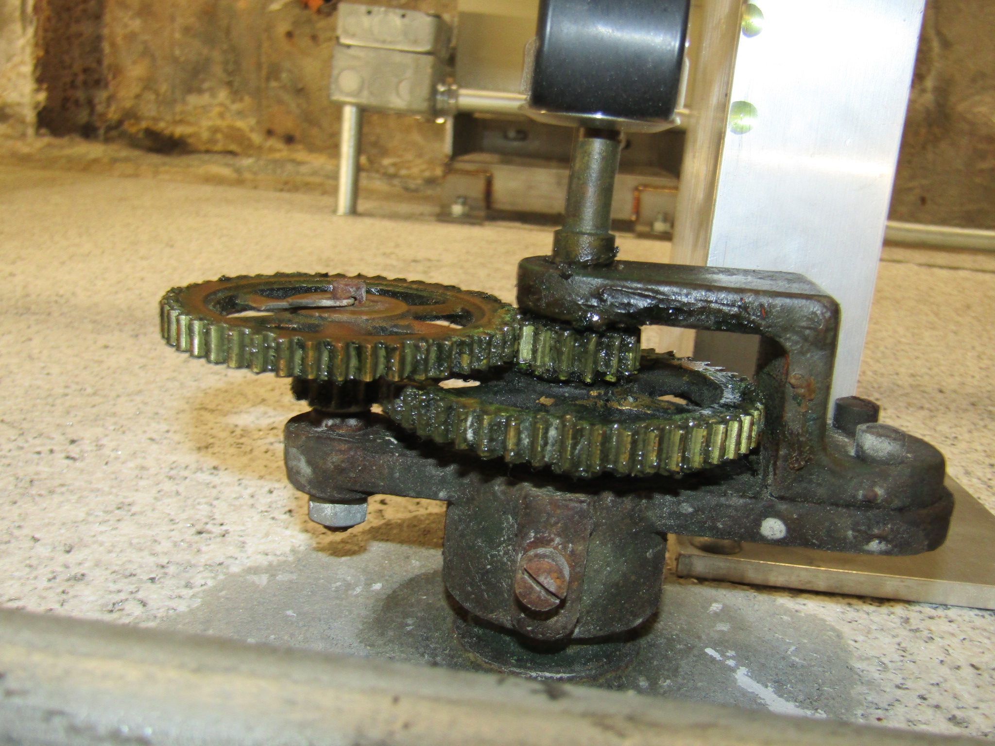 There are four clock faces, and each clock face has four gears that move the clock hands.