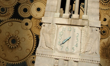 NC State Belltower on a backdrop of golden gears.